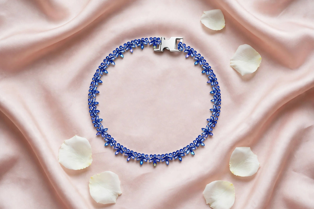Sapphire collar flat lay on blush silk