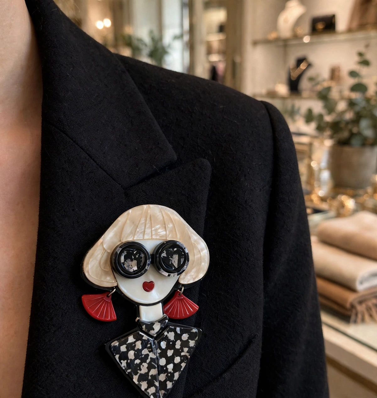 Fashionista brooch worn on a black blazer