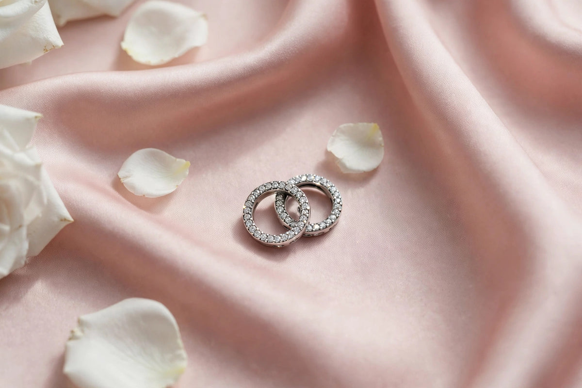 Petite crystal charm flat lay on blush silk