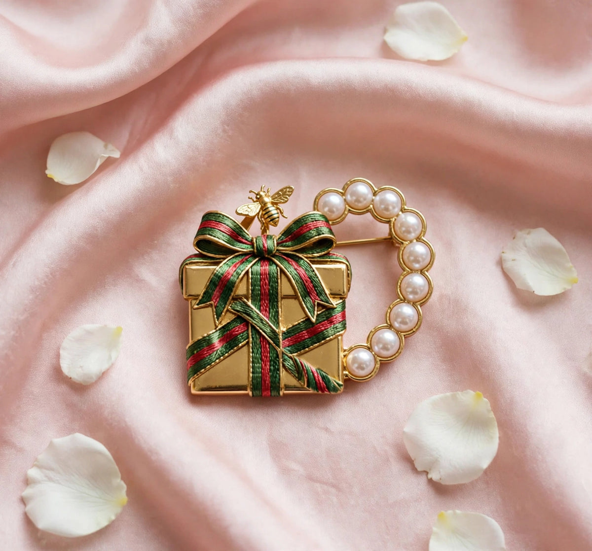 Present brooch flat lay on blush silk